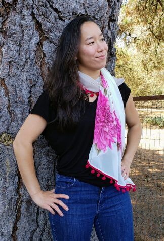 Woman wearing Pink Flowers on Off White, Fuchsia Pom Poms