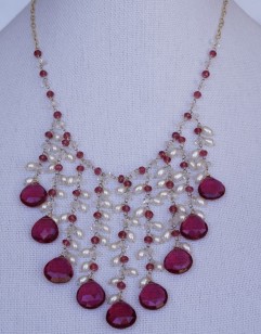 Rubelite, ruby and herkimer diamond necklace on display